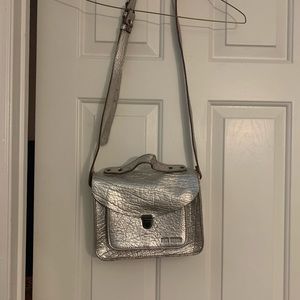 Brand new silver leather crossbody bag.  Never used. 9.5 in(w) x 8 in(l) x 2.5